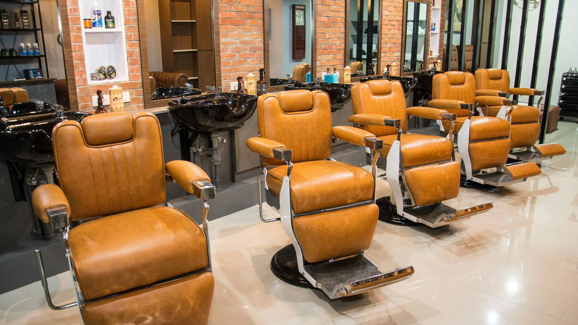 Interior of a light, contemporary salon with product shelving and styling stations