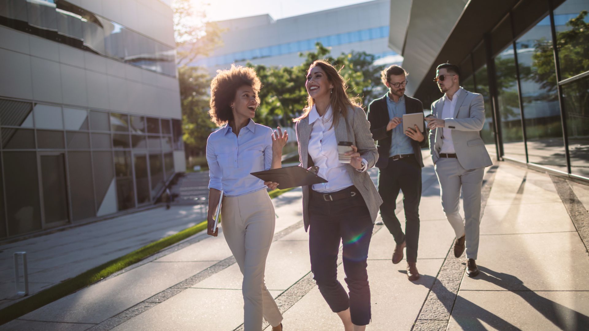 Advisory colleagues walking together outside the offices