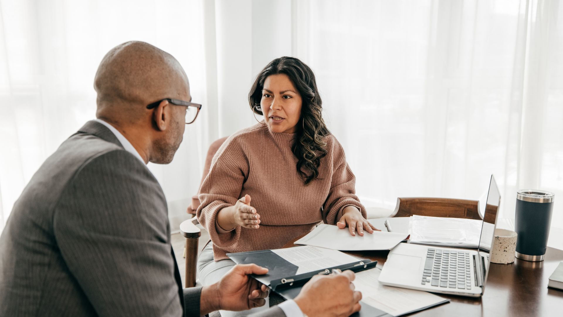 Two advisers reviewing a document during a client consultation