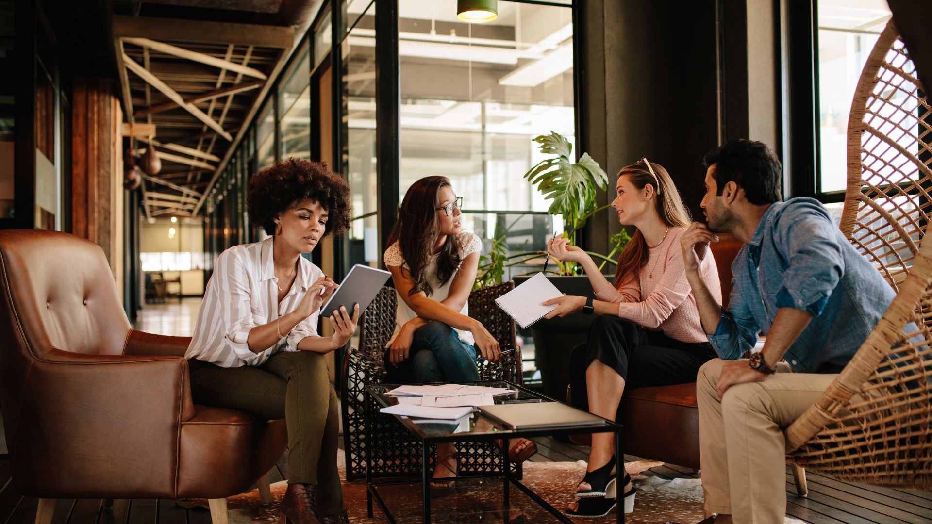 Colleagues in discussion in an open studio area of the firm