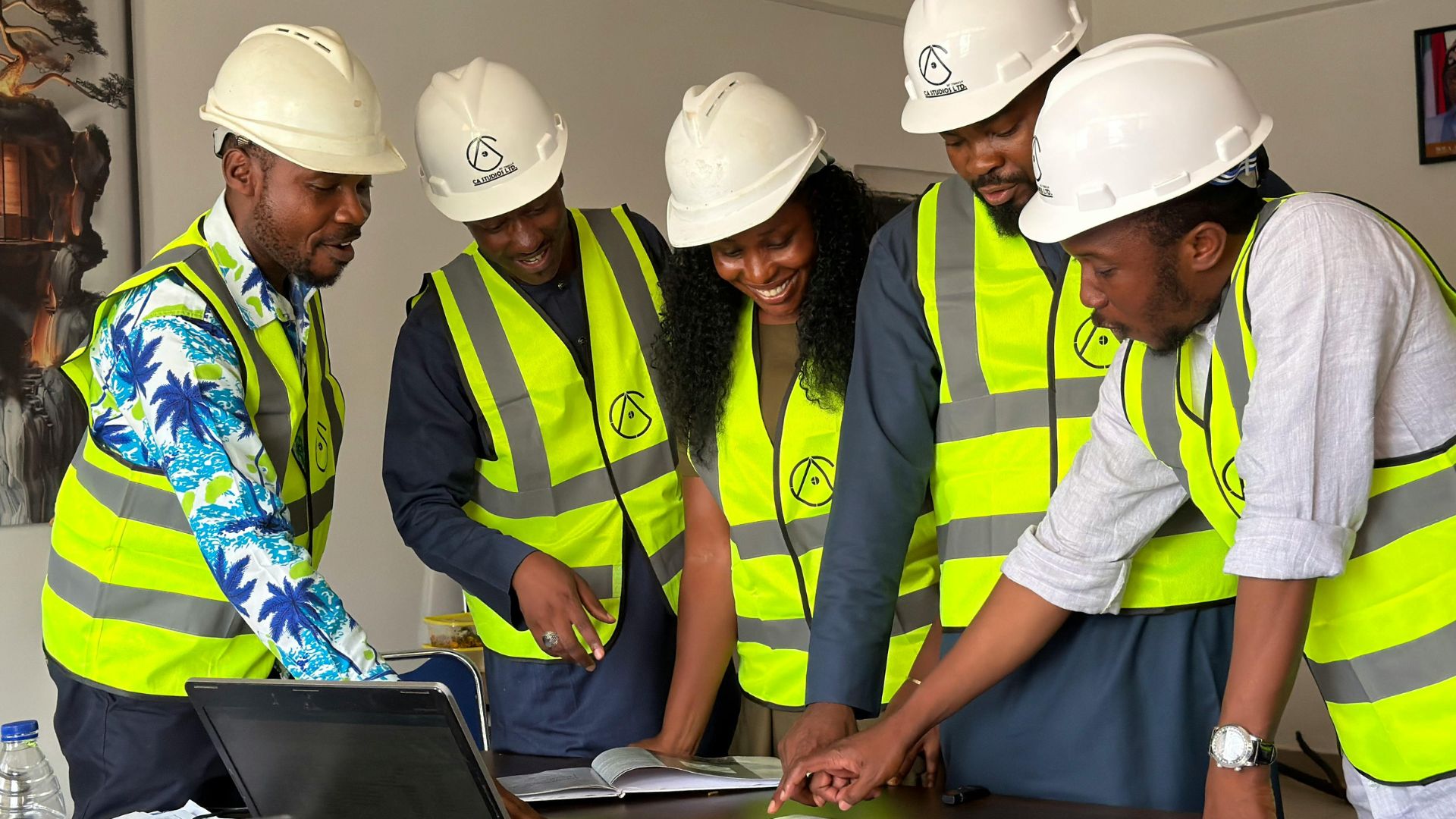Project team reviewing programme and drawings around a table