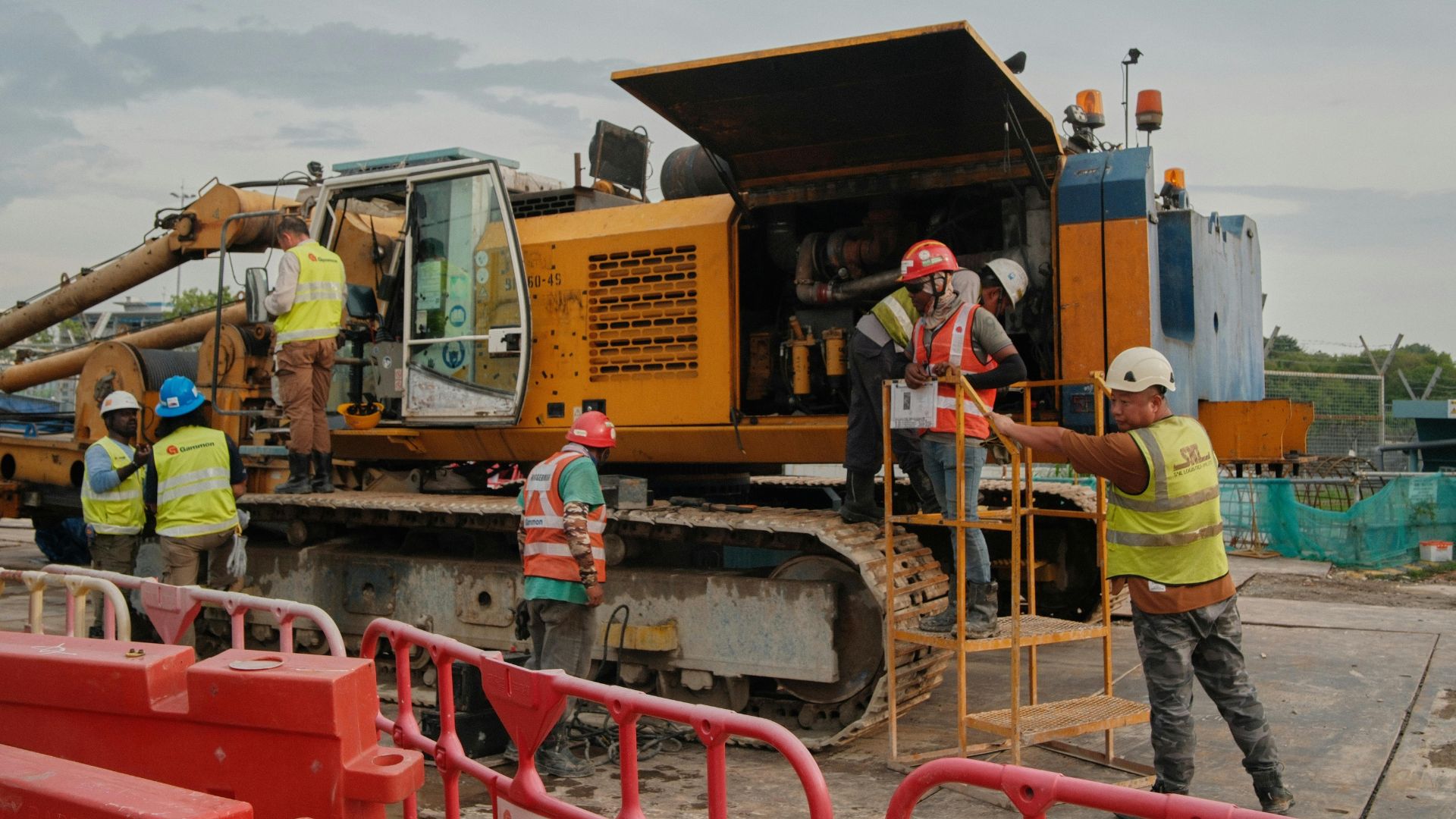 Piling rig and crew setting foundations on a commercial site