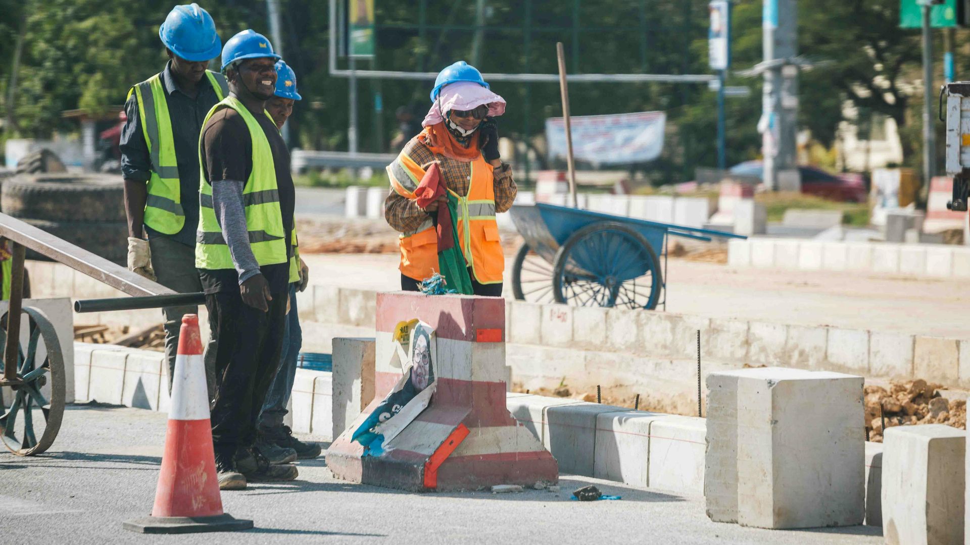 Roadworks crew laying kerbing along a new carriageway edge