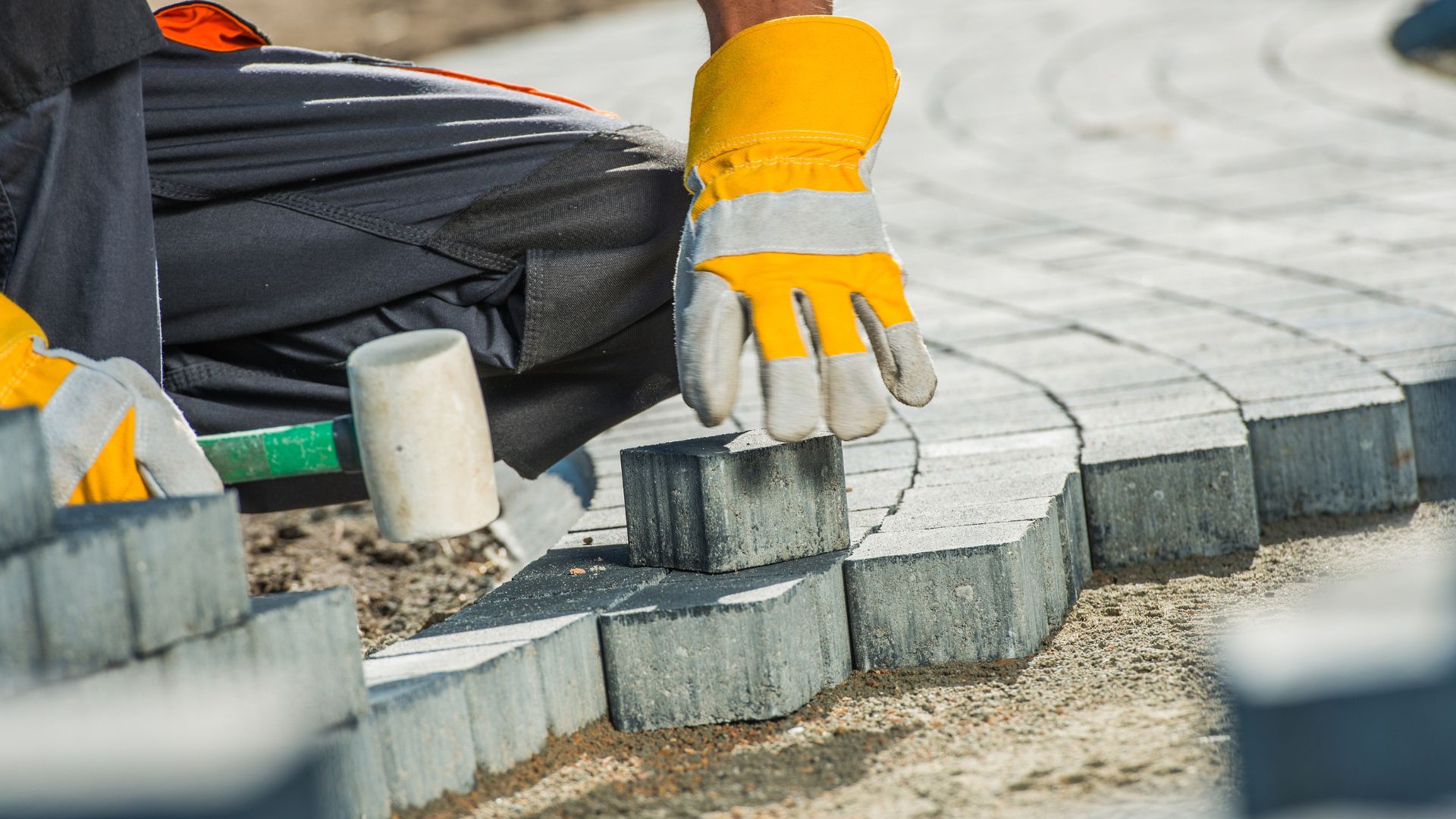 Close detail of interlocking paving blocks being laid to pattern